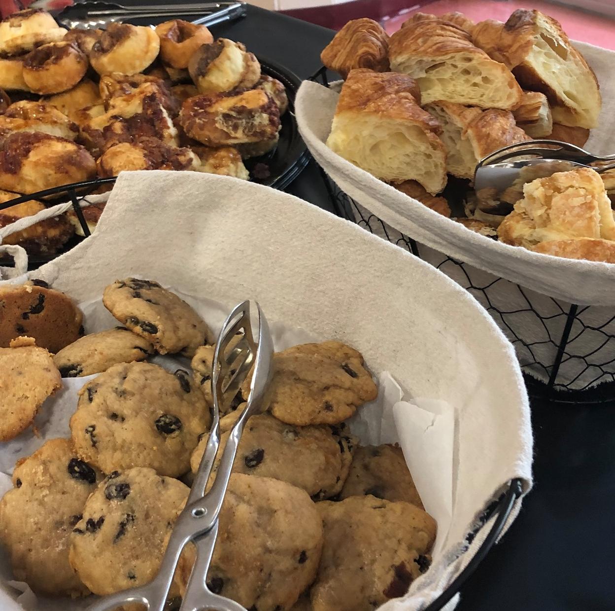 Cookies, cinnamin buns, pastries, and other baked goods served in baskets
